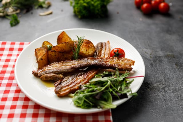 Crispy Rib Ensemble with Roasted Potatoes and Vibrant Greens